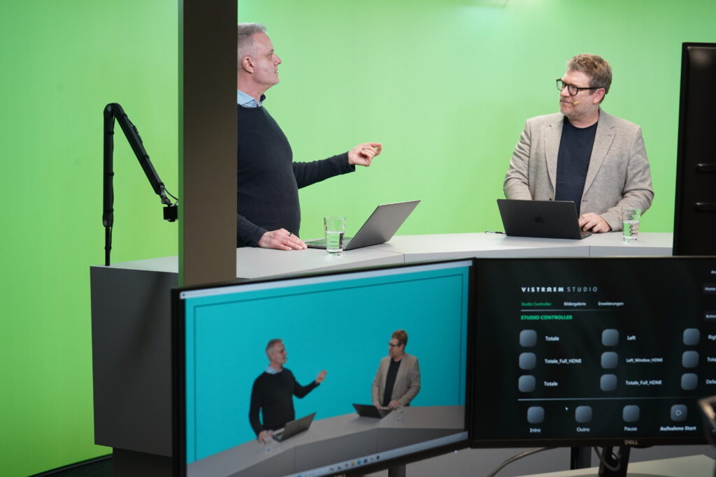 two men filming in the conference studio